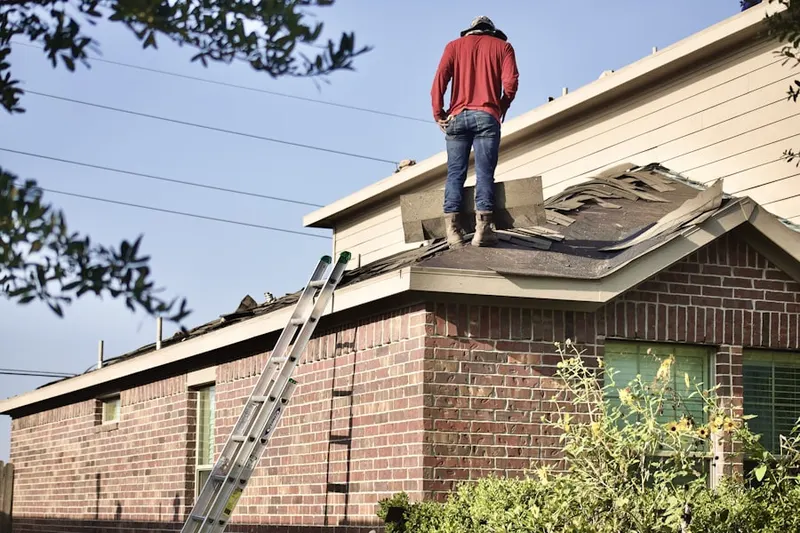 Professional roofer working on a residential roof in Bradley Hills Grove